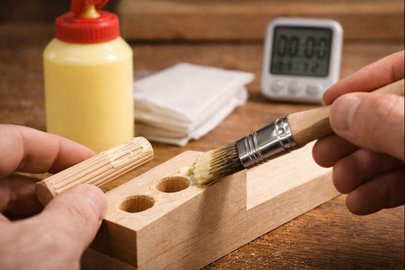 brushing glue on the hole walls for even coverage