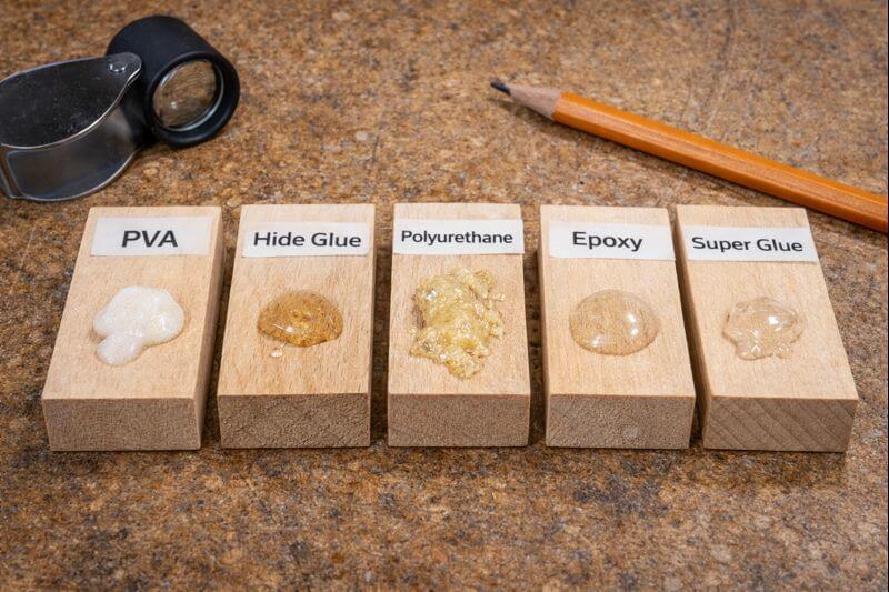 cured adhesive samples labeled on small wood blocks