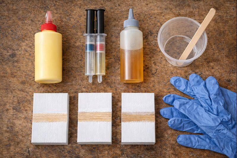 adhesive types beside scuffed painted wood samples