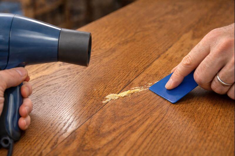 warming glue residue on finished oak tabletop