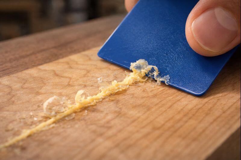 plastic card scraping glue film from maple