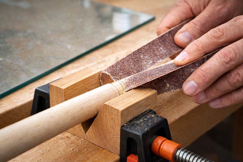 cutting a dowel with sandpaper strap technique